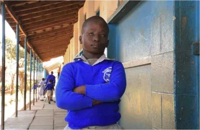 Amos outside his classroom at Kilimani Primary School