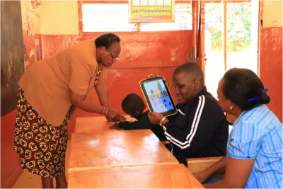 Collins Mwendwa showing off the pictures in his digital textbook