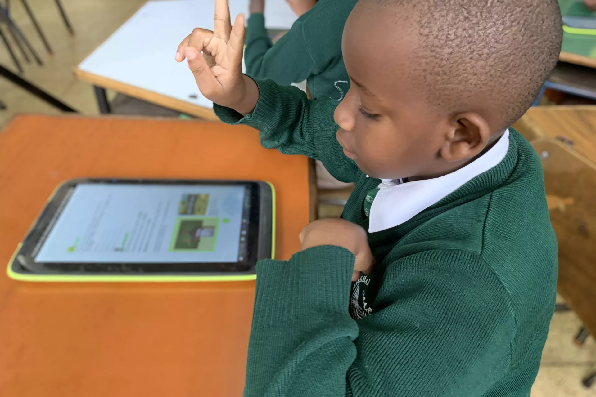 Boy who is deaf learning with an accessible textbook on a tablet