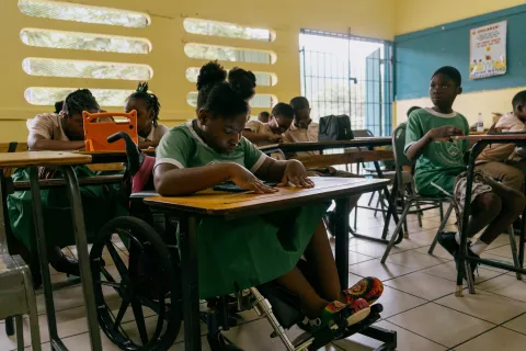 A young girl with a disability learning with technology