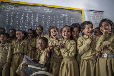 Students pose for photograph inside their classroom at a government primary school in Uttar Pradesh, India