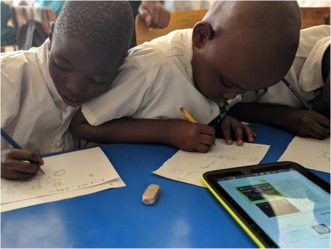 Derrick and Collins learning how to write with the help of the digital accessible textbook