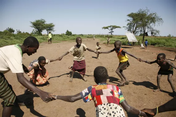 Karamojong children join hands in a game of ‘ring around the rosy’ during an ABEK class in a ‘manyatta’ (semi-permanent village) near Naitakwaé Town in the north-eastern Moroto District